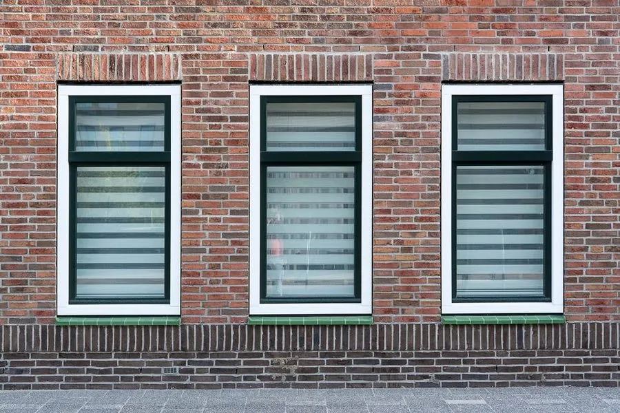White uPVC replacement windows on a brick house exterior