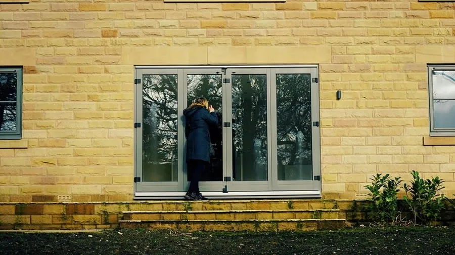 Bi-fold glass doors opening onto garden patio from Exeter home