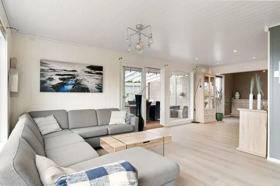 Bright interior living room flooded with light from bi-fold doors