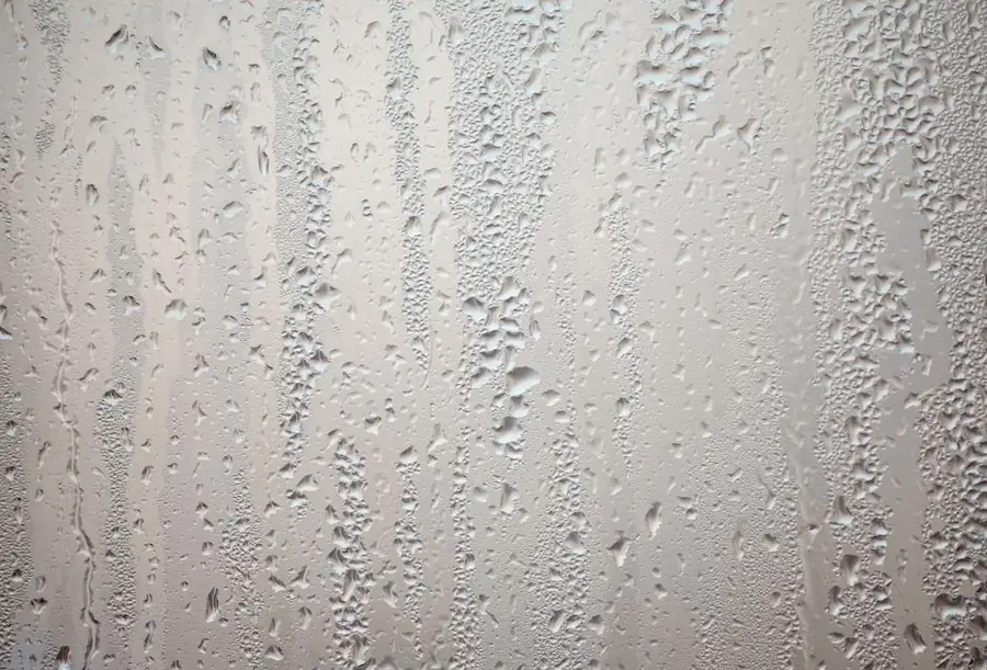Water droplets and condensation on the inside surface of a window in an Exeter home