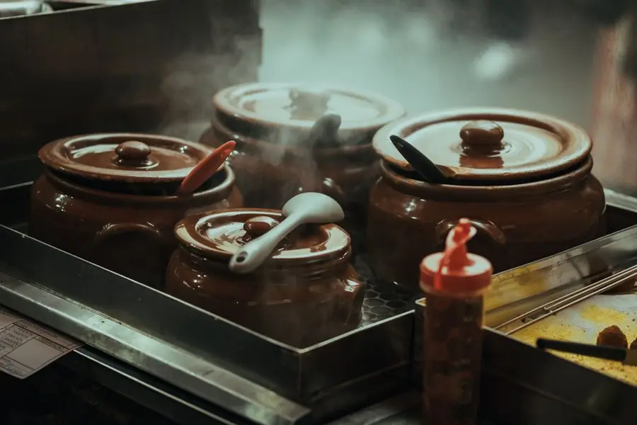 Steam rising from a cooking pot on a hob - cooking without lids adds litres of moisture to indoor air daily