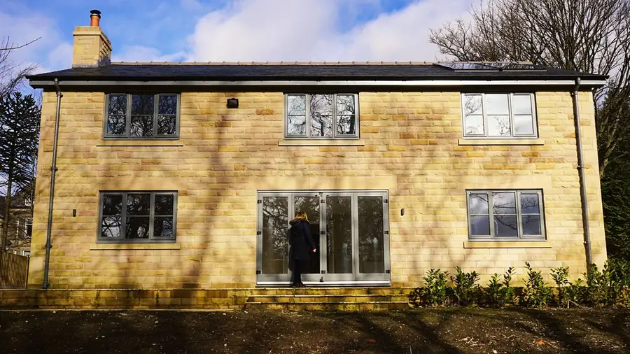 UK home with replacement aluminium French doors linking house and garden