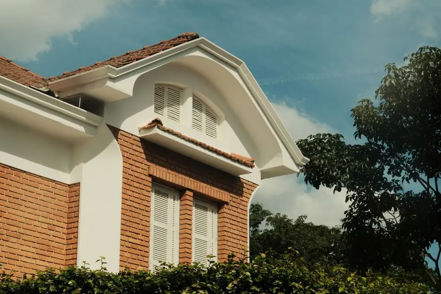 Modern house with white double glazed windows on brick facade - new windows and property value in Exeter