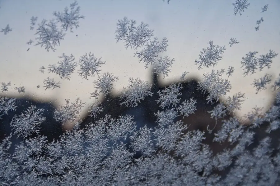 Cold frost on a window pane - old double glazing failing to retain heat in an Exeter property