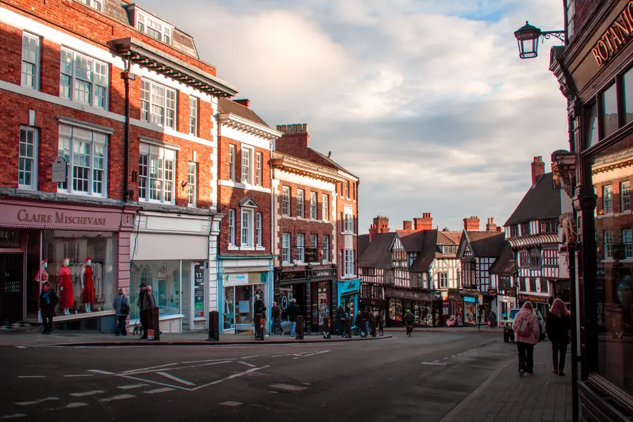 Georgian red brick shop frontages with multi-pane sash windows on the upper floors, similar to the rebuilt frontages on Honiton High Street