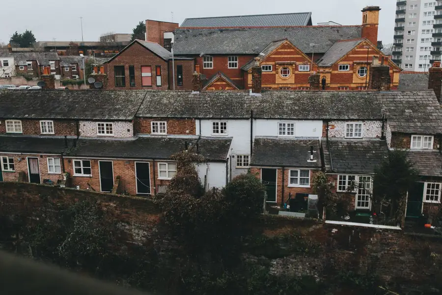 English brick terraced houses with a mix of window styles and frame colours