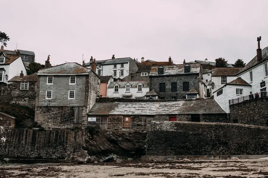 Grey stone and slate-hung town houses stepped up a hillside with white-framed windows, similar to the older streets of a West Devon market town like Okehampton