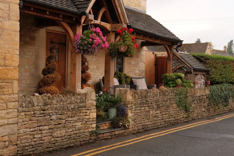Oak framed porch on a stone cottage entrance, an example of a high specification porch build in Devon