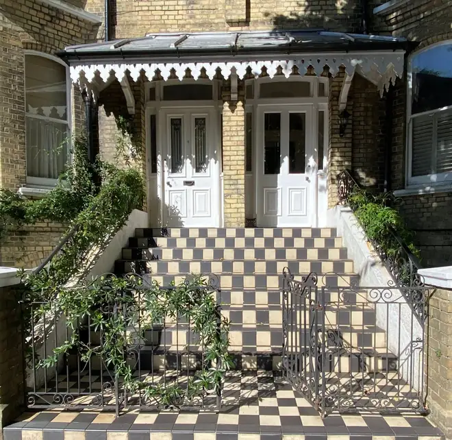 Victorian entrance with a covered canopy and tiled steps, showing an original front door retained behind a porch
