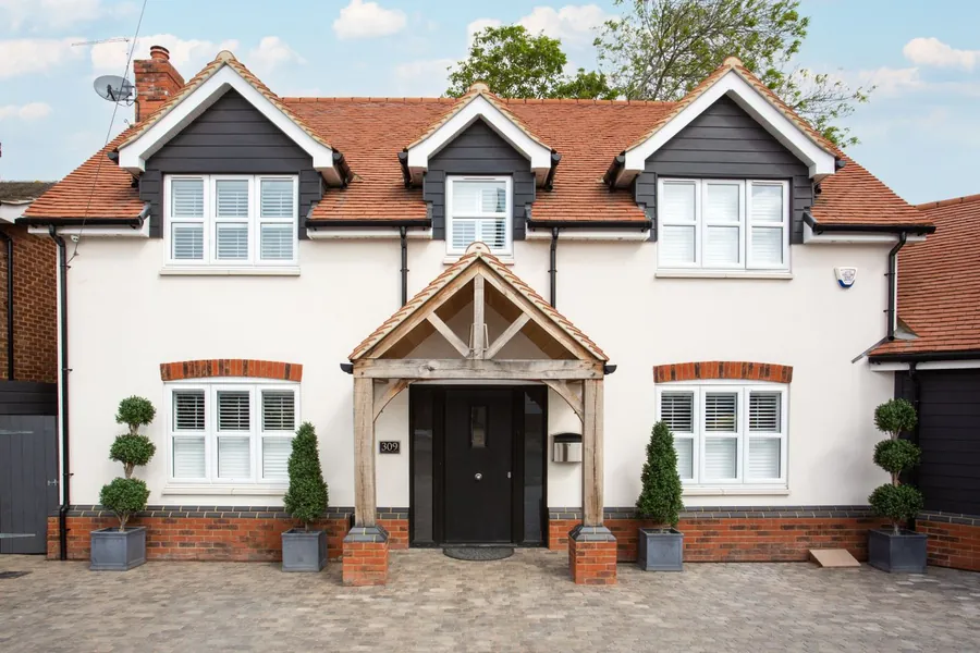 Oak framed porch canopy over a front door on a UK house, an entrance porch within permitted development limits