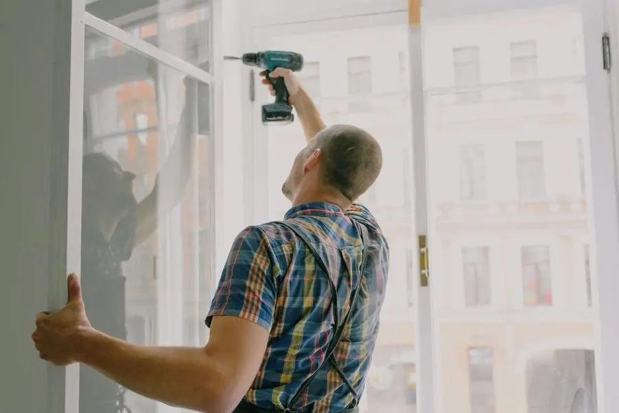 Window installer fitting a panel - secondary glazing installation in an Exeter property
