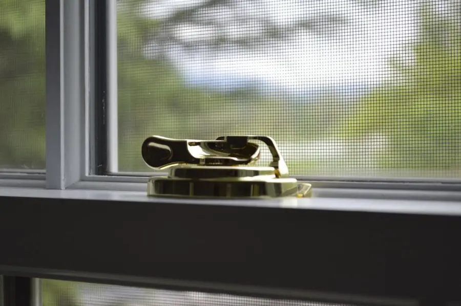 Close-up of a brass window lock mechanism - window security and locking issues in Exeter