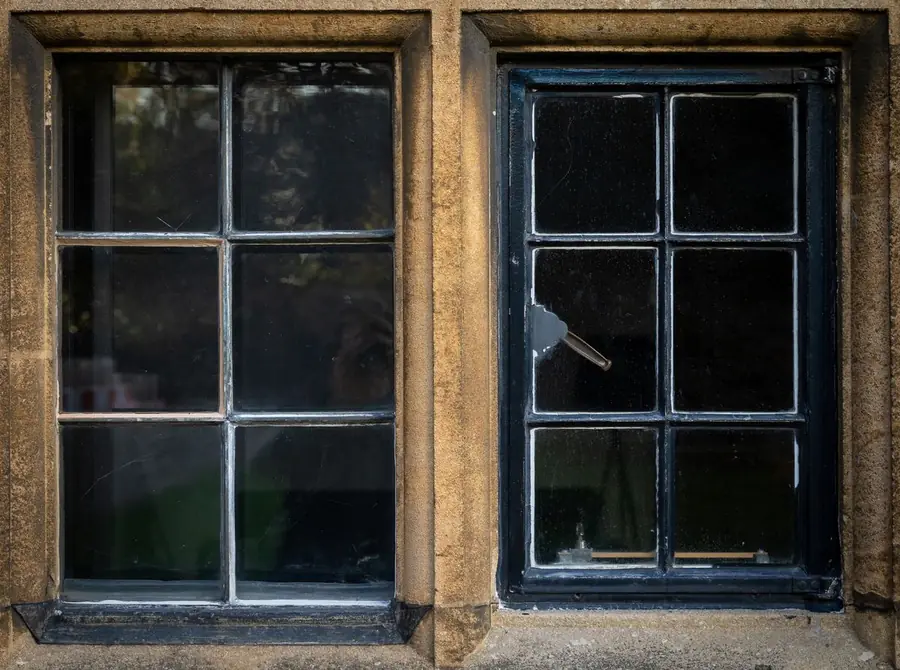 Timber casement windows set in a stone surround, the arrangement that suits cob and solid wall homes near Exeter