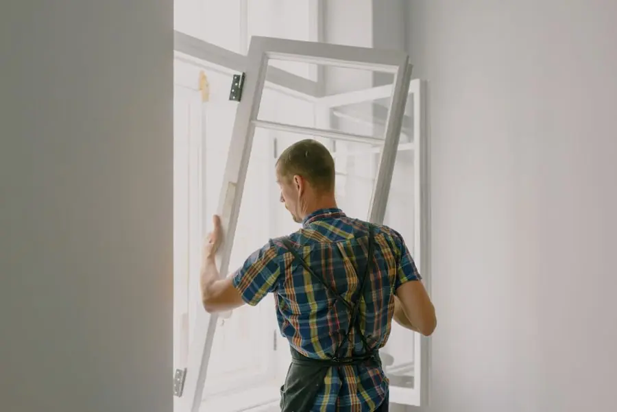 Window installer professional fitting a new window in a property