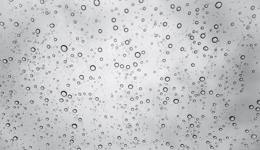 Rainy weather seen through a window - Devon's wet climate and window material choice for Exeter homes