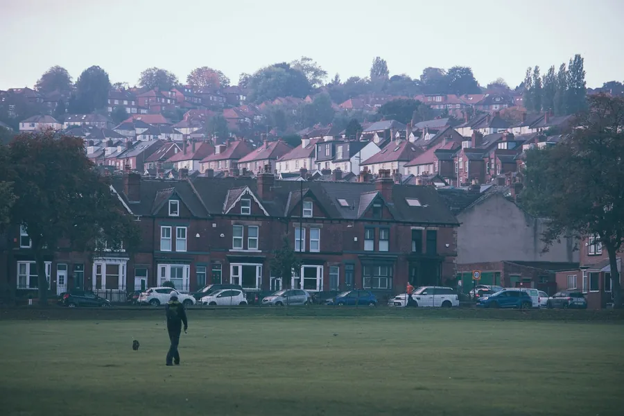Rows of terraced and semi-detached houses on a hillside on a misty morning