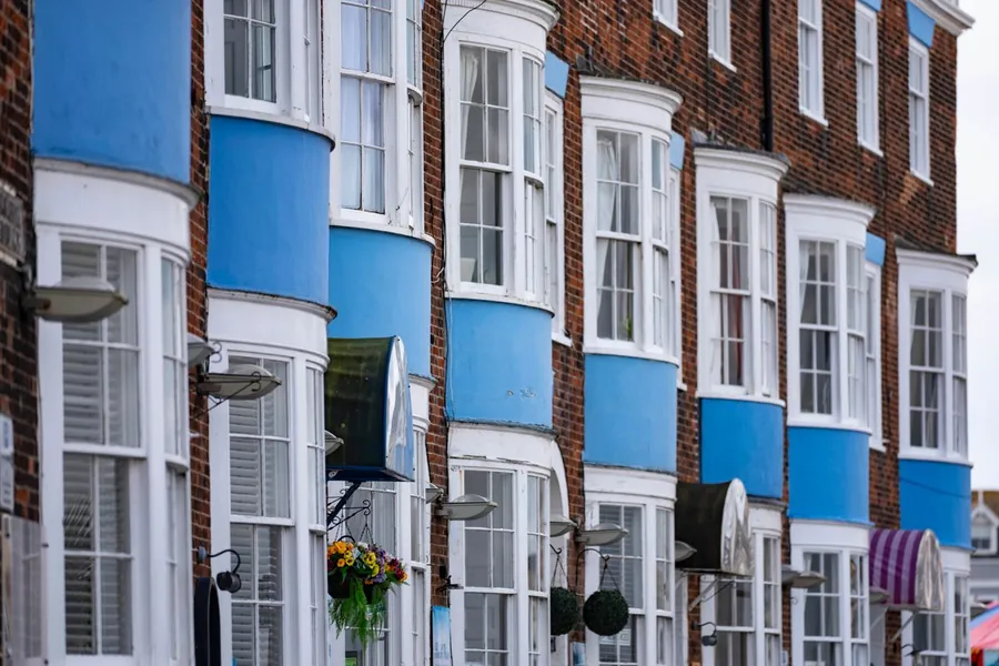Victorian seafront terrace with painted bay windows and sliding sashes, the kind of frontage East Devon District Council protects in Exmouth's conservation area