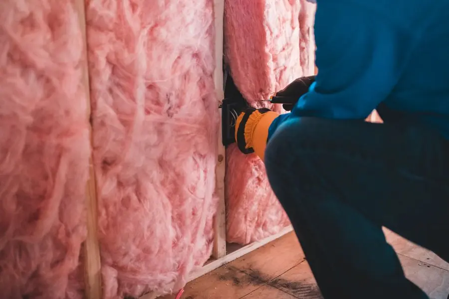 Loft insulation being installed - the Warm Homes scheme prioritises insulation and heating over glazing
