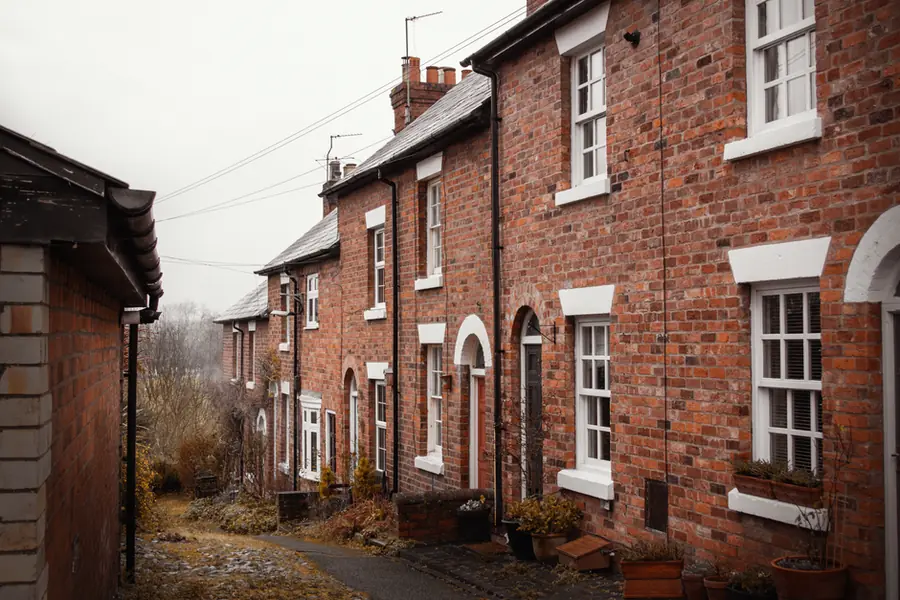 Brick terraced houses on an English street - many of Exeter's older terraces sit at EPC band D or below