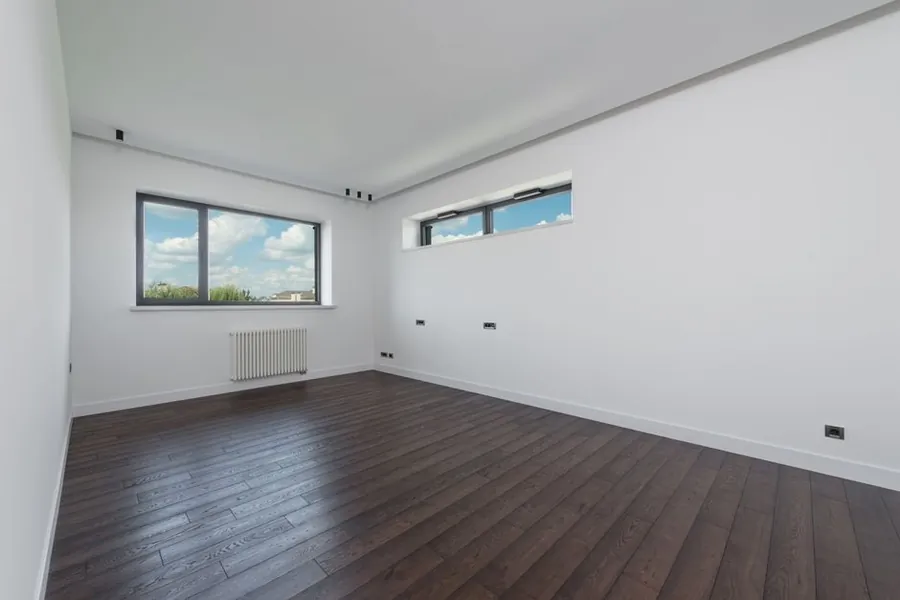 Room cleared of furniture with large window openings ready for replacement windows
