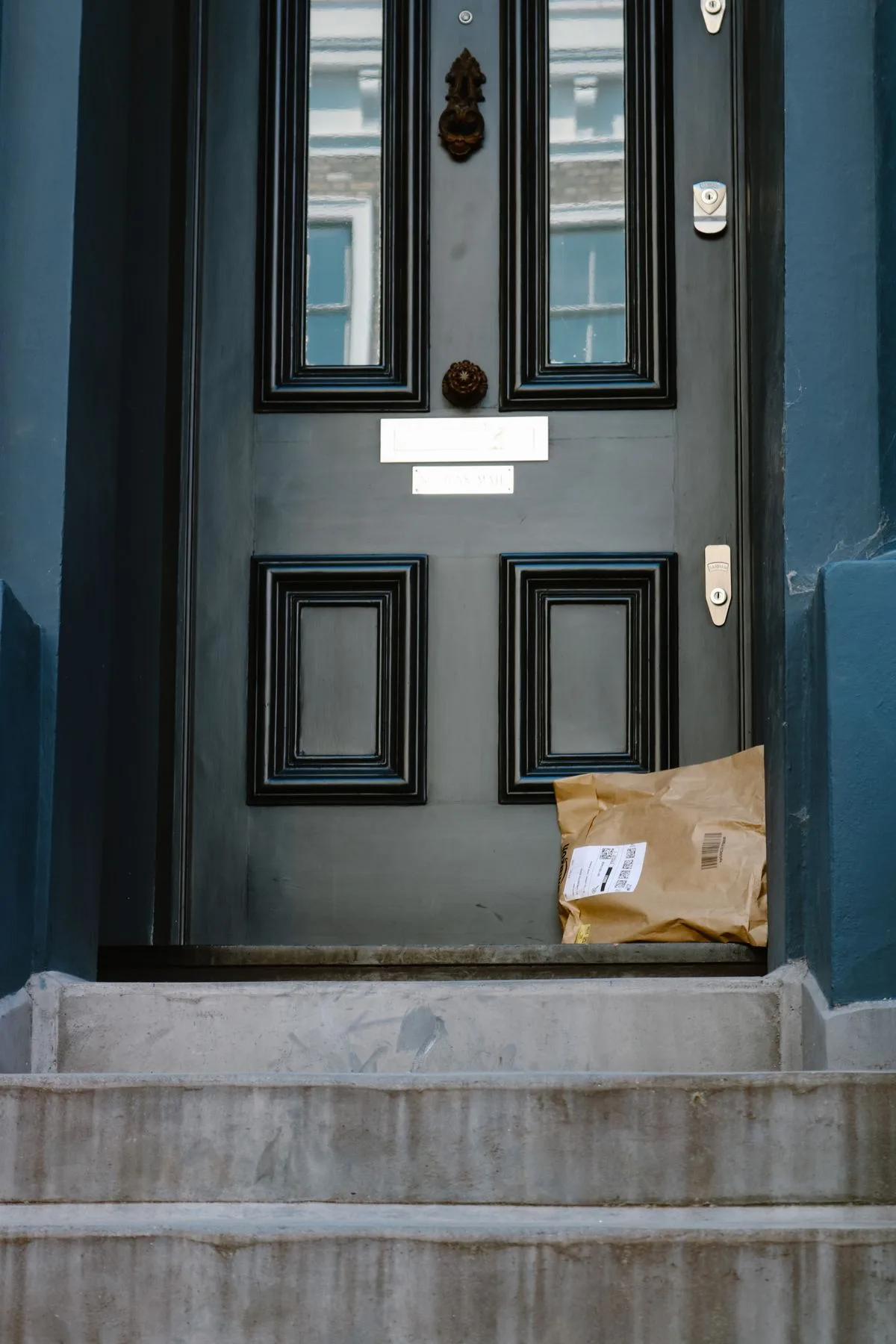 Black composite front door on stone steps - composite door installation in Exeter