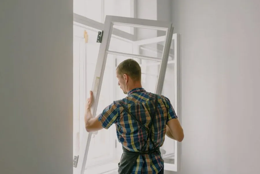 Installer fitting a new door frame in an Exeter property