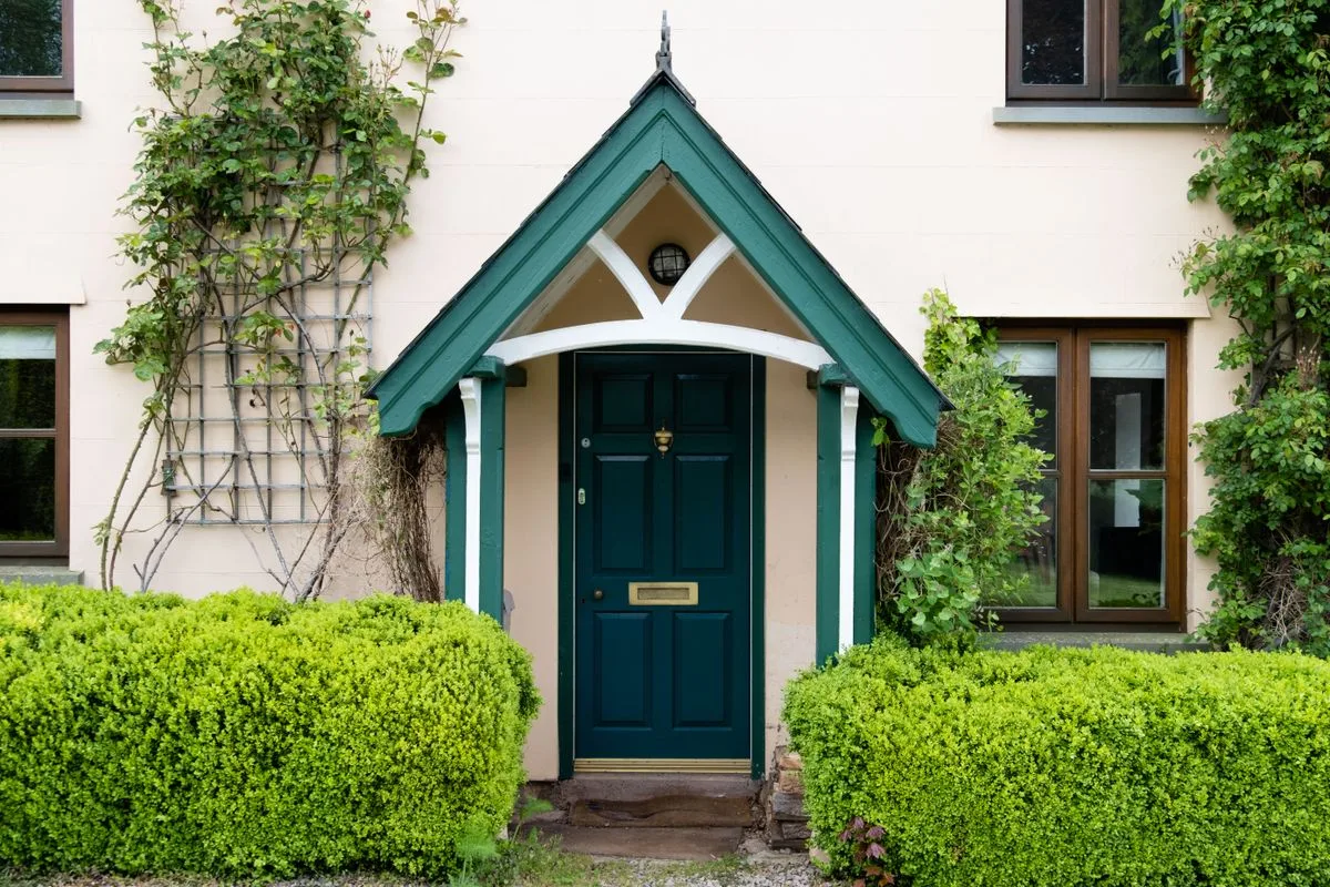 Cottage with green stable door - stable door installation in Exeter
