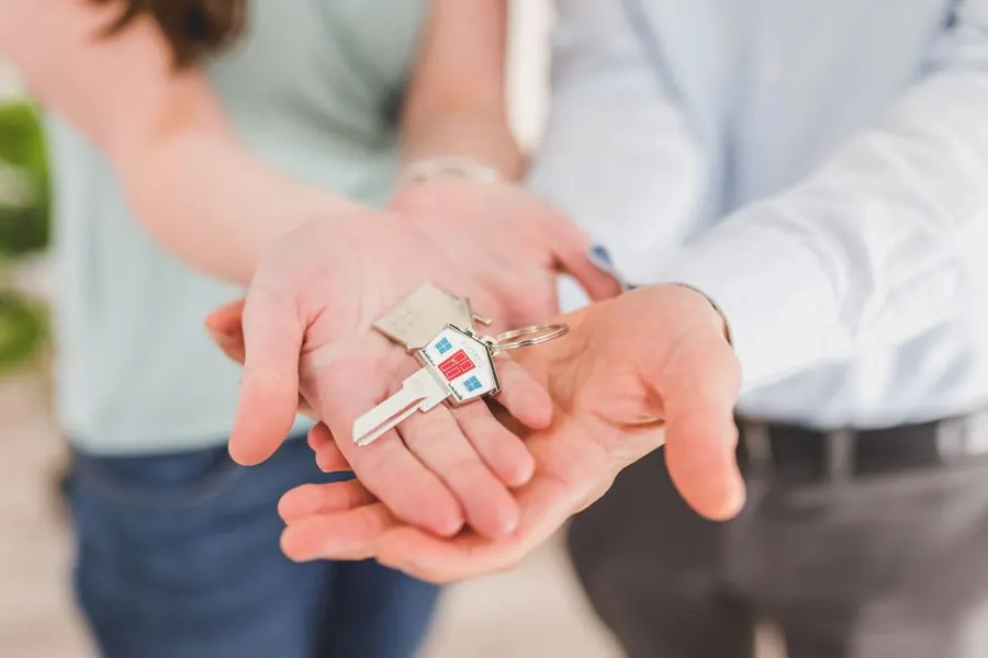 Keys handed to a new owner of an Exeter home with recently installed double glazing