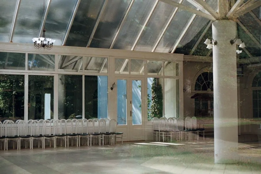 Glazed conservatory with a glass roof on the rear of a home near Exeter