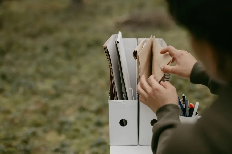 Homeowner sorting through folders of property documents looking for a window certificate