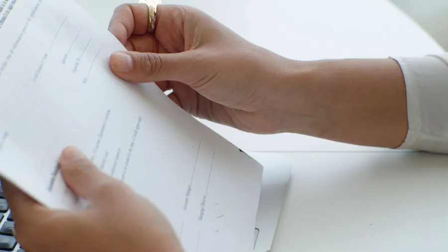 Homeowner reading the small print of a replacement window contract in Exeter