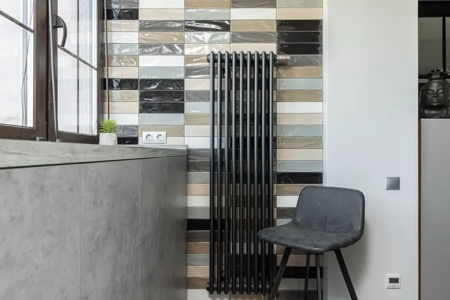 Warm living room interior with a radiator beneath the window in an Exeter home
