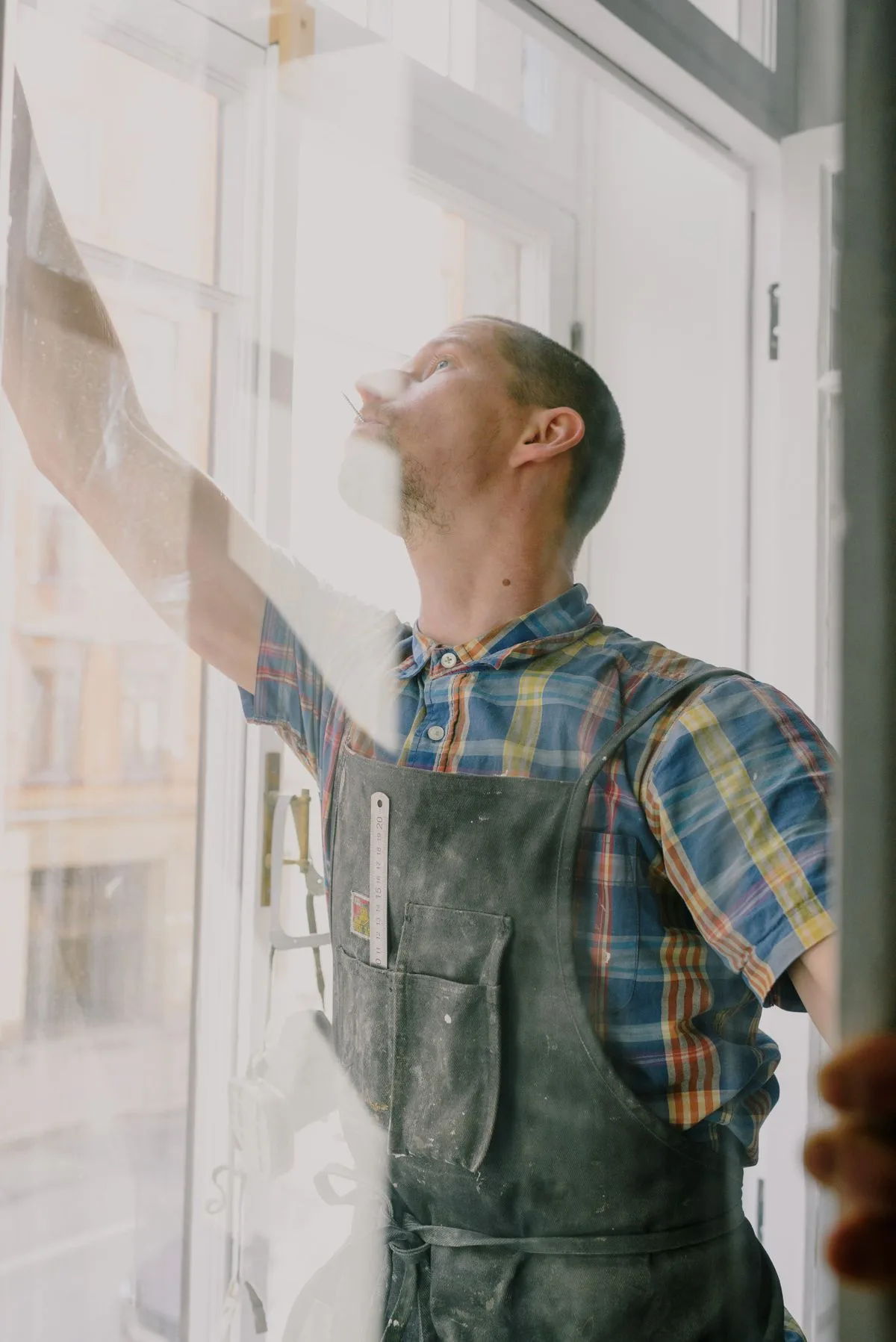 Craftsman assembling uPVC window with self-cleaning glass in Exeter