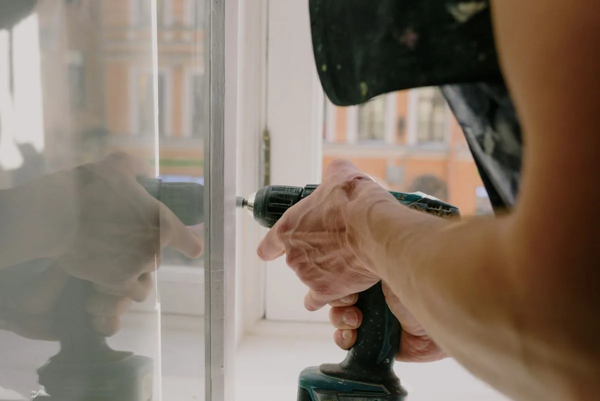 Installer assembling white uPVC window frame in Exeter