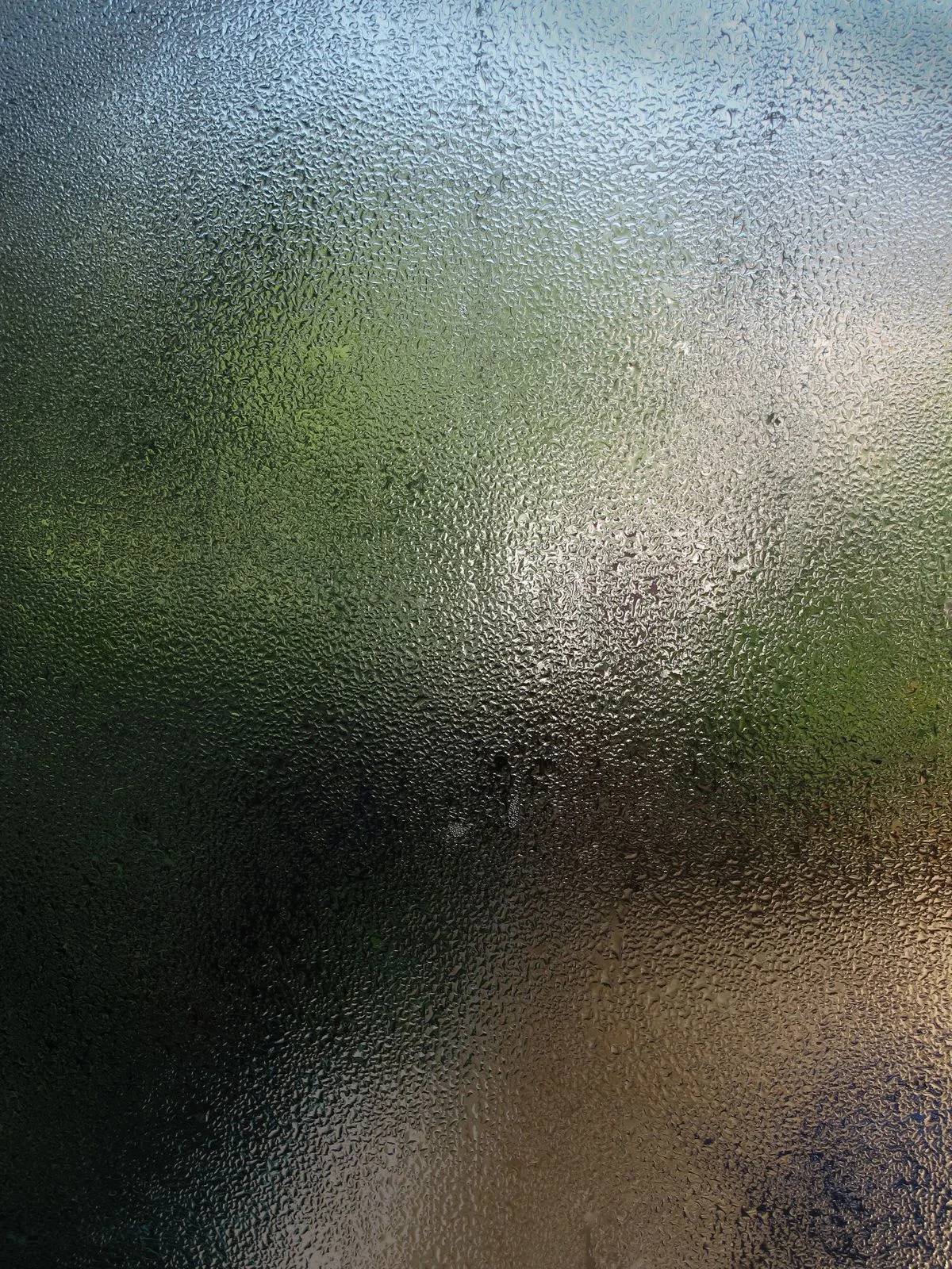 Window with condensation and water droplets - window repair in Exeter