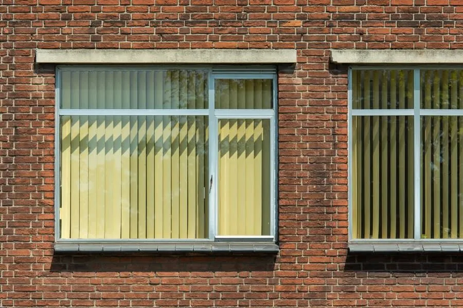 Close view of replacement windows set into a brick facade in Exeter